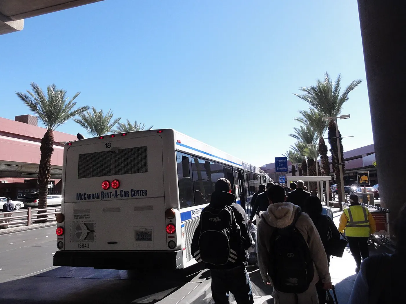 Travelers board a rental car center shuttle at the Las Vegas airport